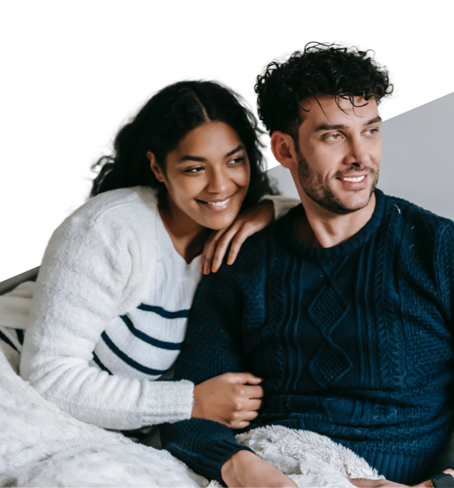 A young couple- man and woman sitting next to each other,